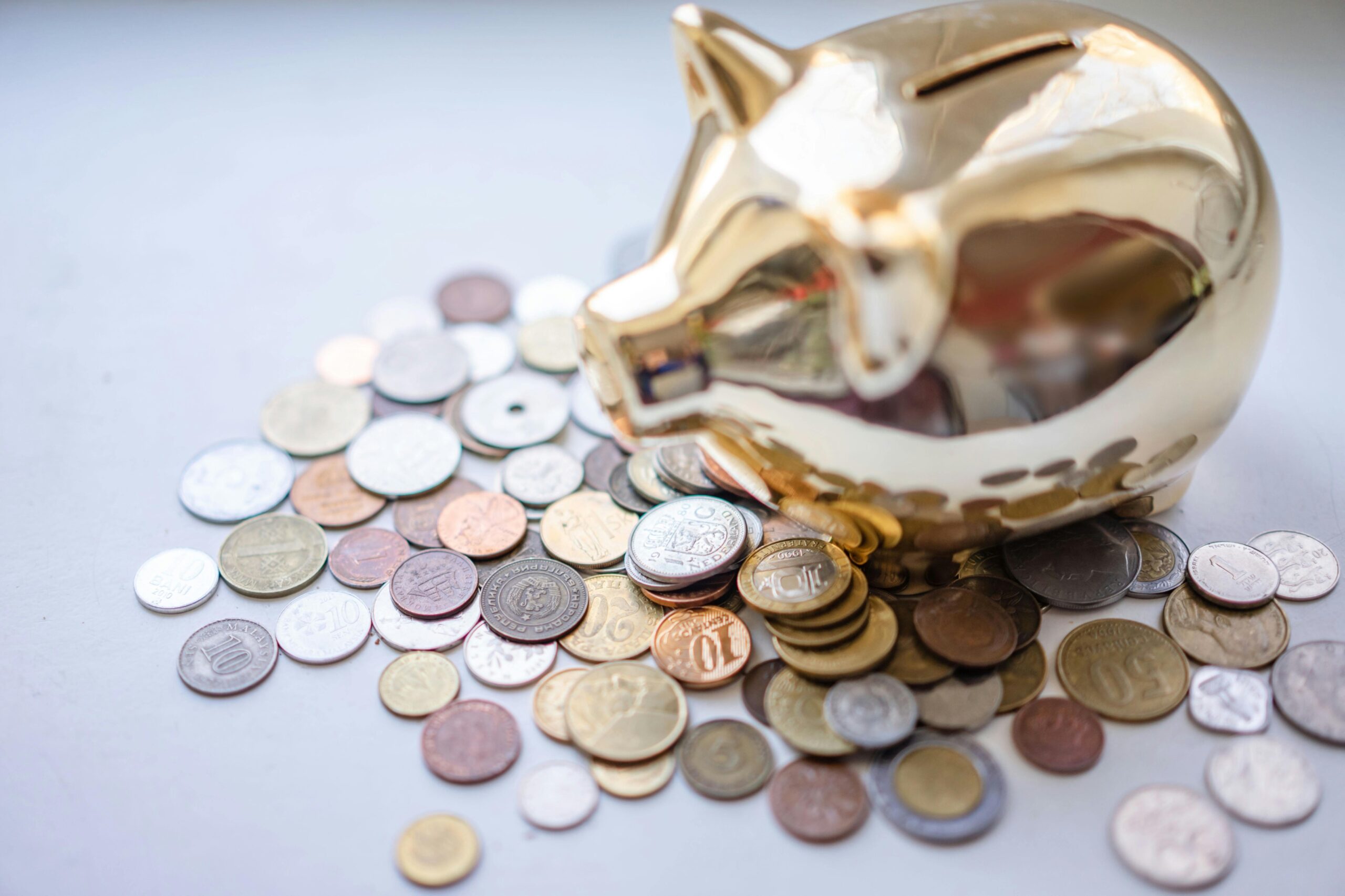 A glass jar labeled ‘Emergency Fund,’ filled with coins and notes.