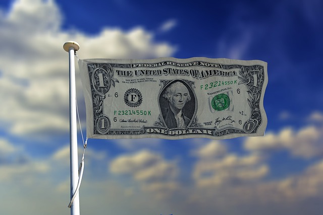 Dollar hanging on a flag, symbolizing the dominance of the U.S. dollar in December 2024 global markets