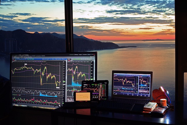 Computer with stock chart, sunset view symbolizing the future of finance.