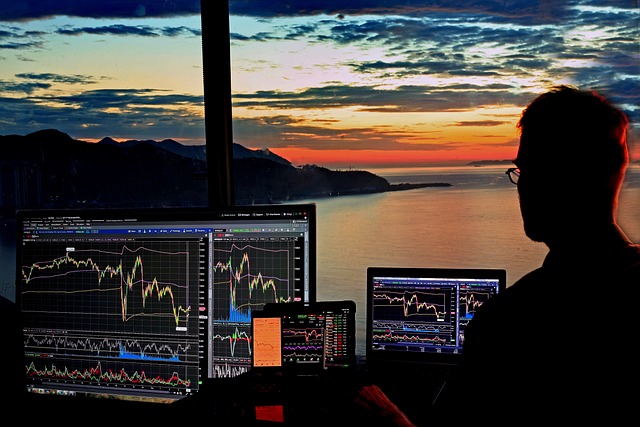 Person analyzing stock market charts to manage emotions during market volatility.